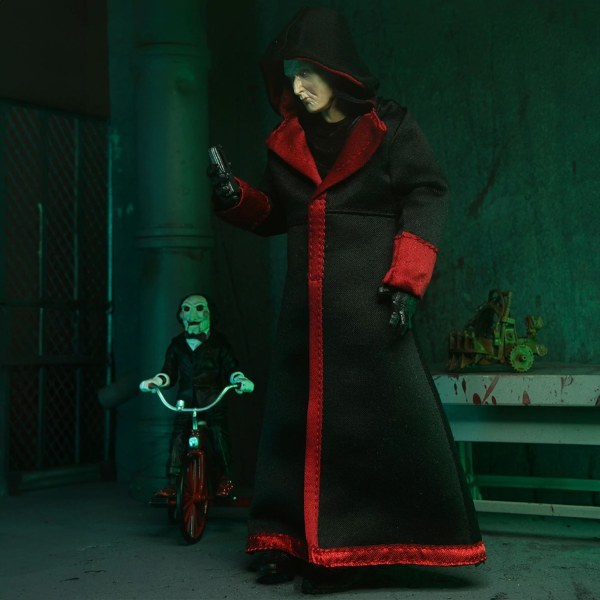 SAW (FRANQUICIA) - FIGURA DE ACCIÓN A ESCALA DE 7” - ULTIMATE JIGSAW KILLER (TÚNICA NEGRA)