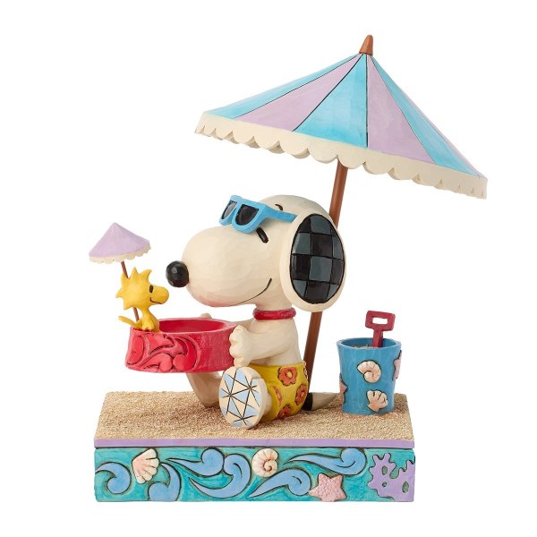 Snoopy sosteniendo a Woodstock en un tazón en la playa - Peanuts